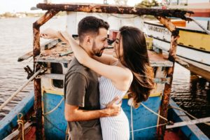 man in gray crew neck t-shirt kissing woman in white tank top